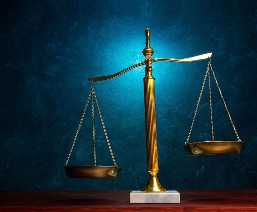 Scales of Justice on blue textured background